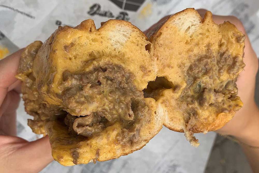 Photo shows a cheesesteak sandwich from Jim's Steaks