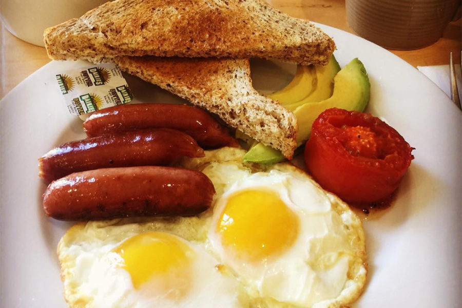 breakfast plate with eggs, sausage, toast, and avocado from the attic cafe in tampa