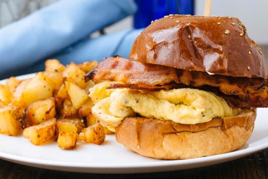 breakfast sandwich with egg and bacon and side of hashbrowns from on point bistro in philly