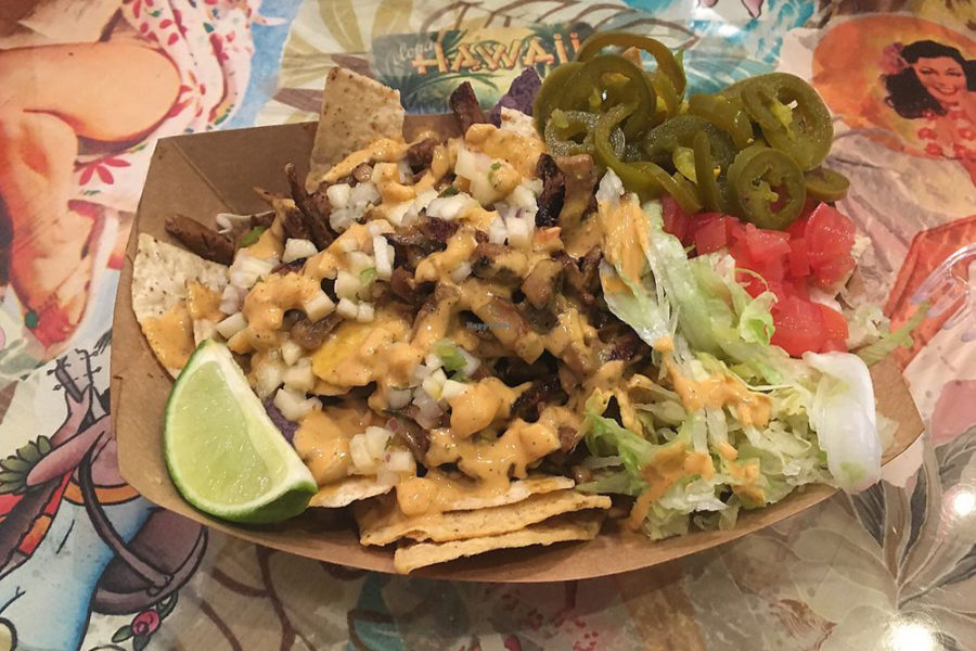 nachos topped with cheese, meat, and veggies from tiki loco in dallas