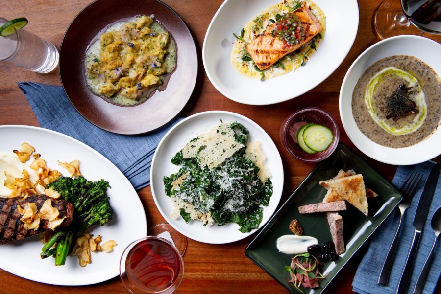 an assortment of entrees from elm and good including steak, caesar salad, salmon, and more