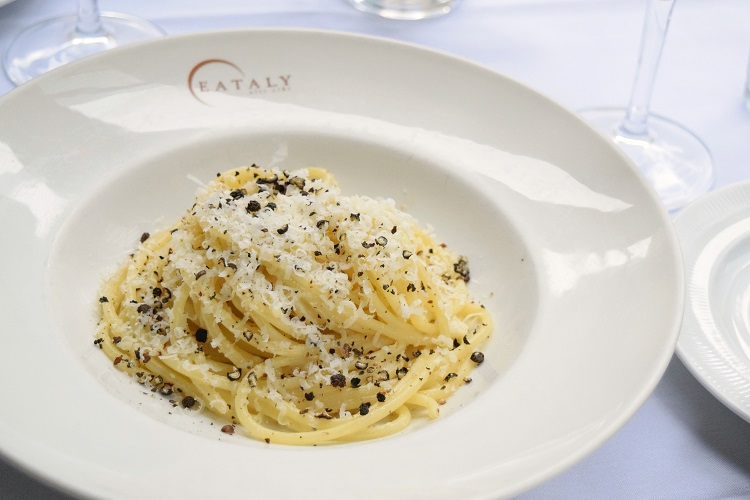 spaghetti with white sauce topped in fresh parmesan flakes from eataly dallas in texas