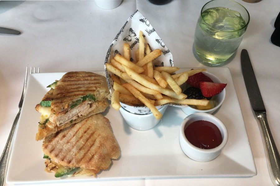 chicken panini with side of fries and fresh fruit from the zodiac in dallas