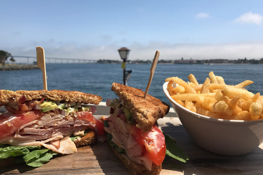 sandwich with roast beef, lettuce, tomato, and avocado along with a side of fries from edgewater grill in san diego