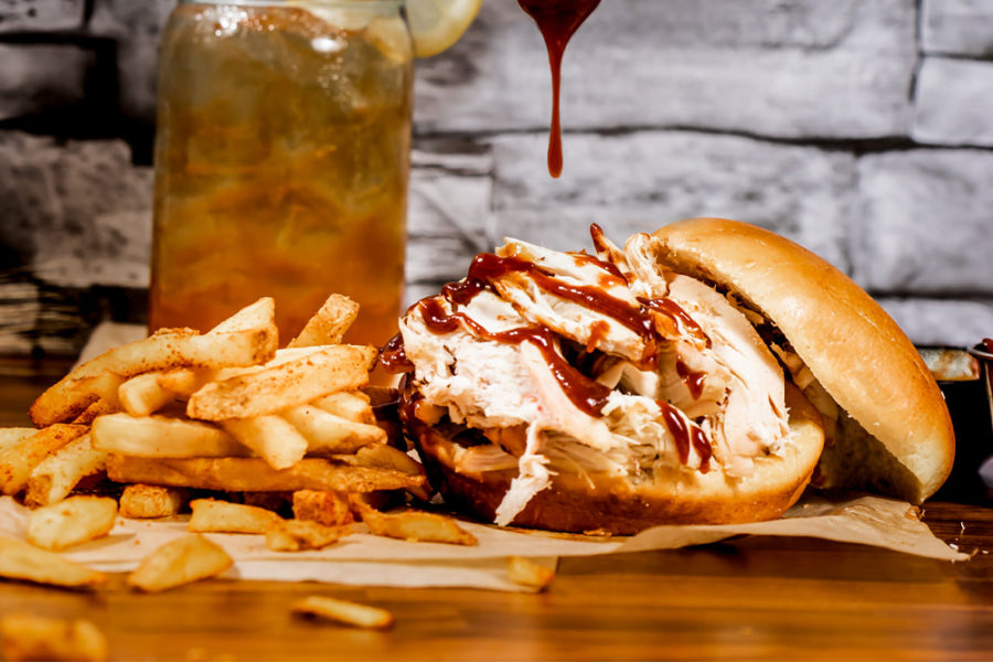 pulled chicken sandwich with side of fries from holy hog barbecue in tampa