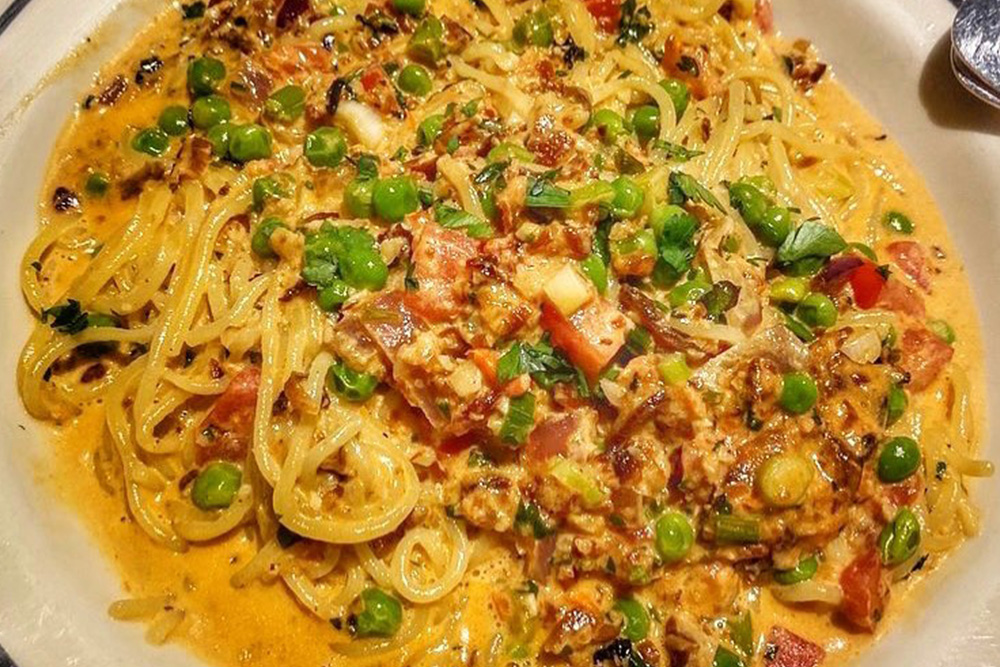 spaghetti dish with red peppers, peas, and ham from bella's italian cafe in tampa