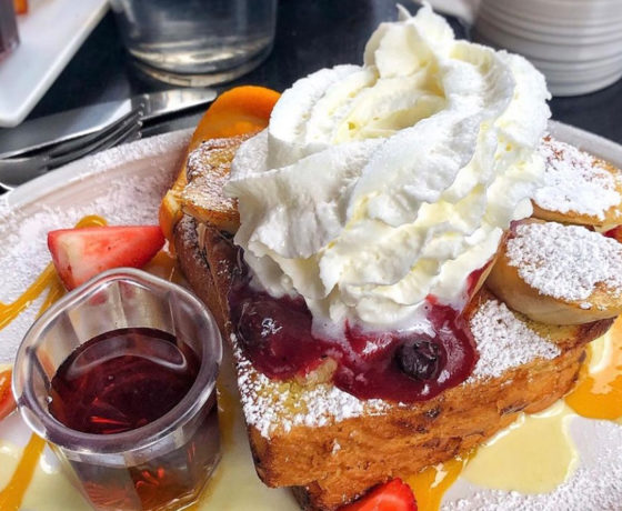 french toast topped with fresh fruit and whip cream from cafe la maude in philly