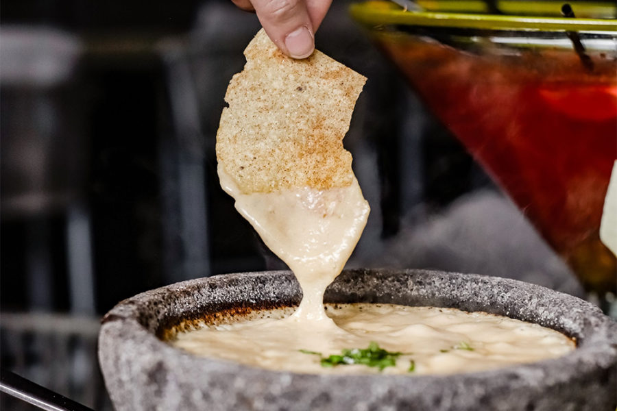 chip being dipped in queso from vidorra in dallas
