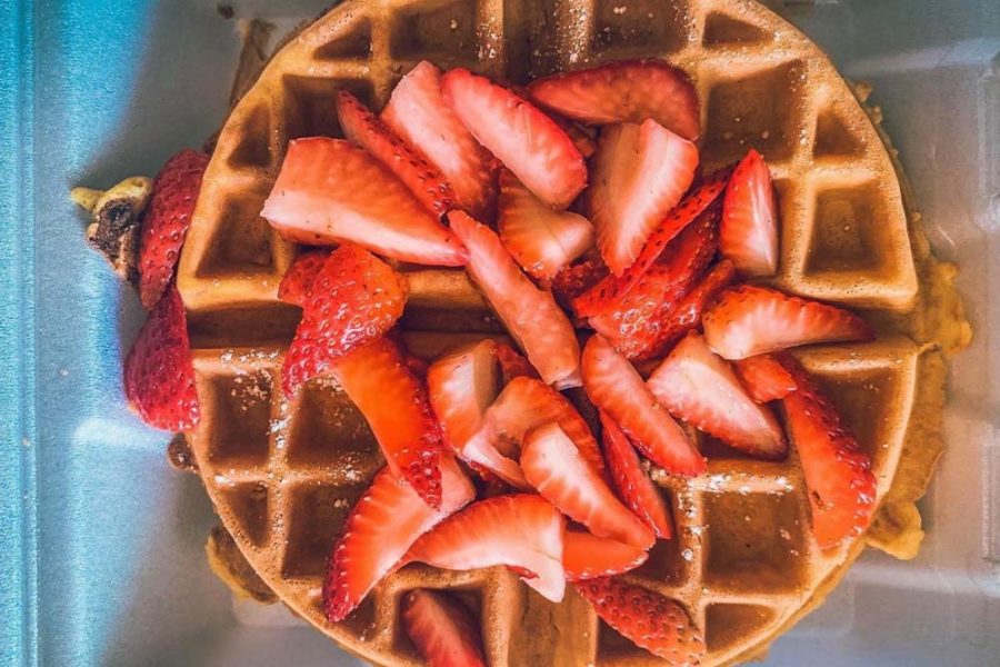 waffles top with fresh strawberries from the broken yolk cafe in san diego