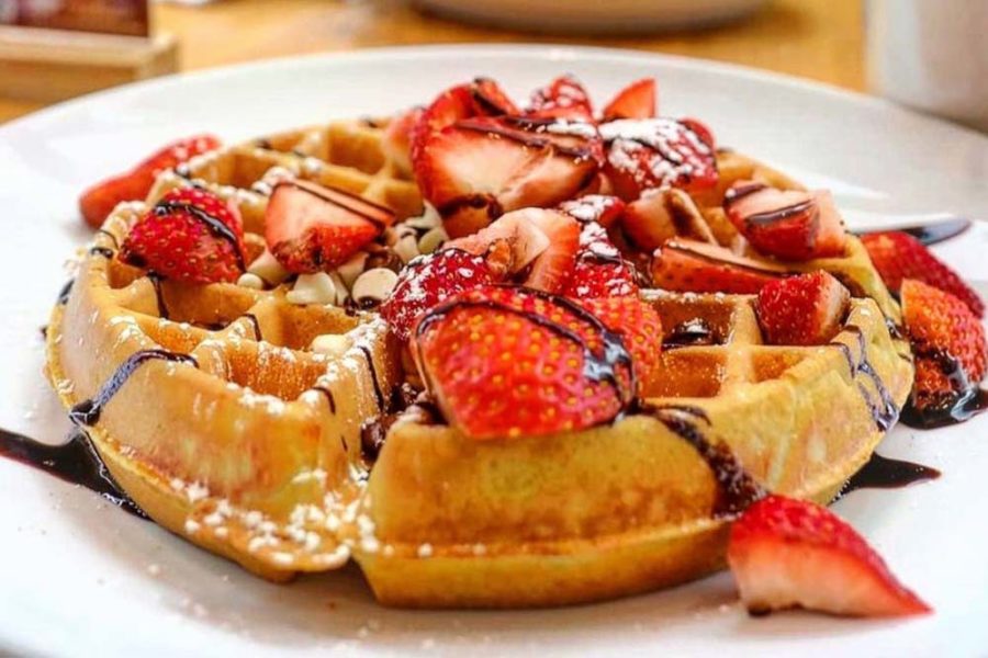 waffle topped with fresh strawberries from wildberry pancakes and cafe in chicago, illinois