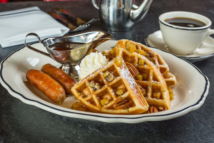waffles with side of sausage and a cup of coffee from the pearl in columbus, ohio