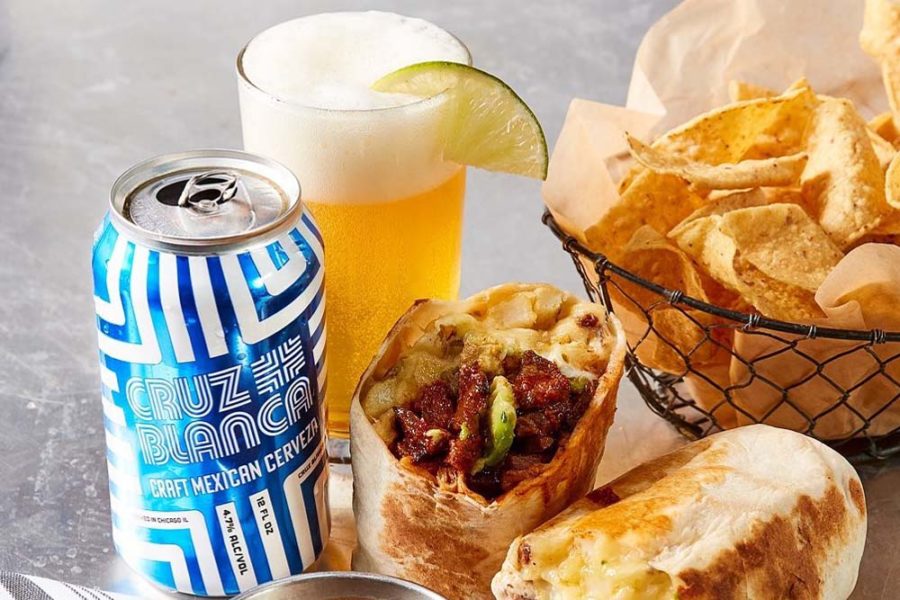 burrito, chips, and cold glass of beer from cruz blanca brewery and taqueria in chicago