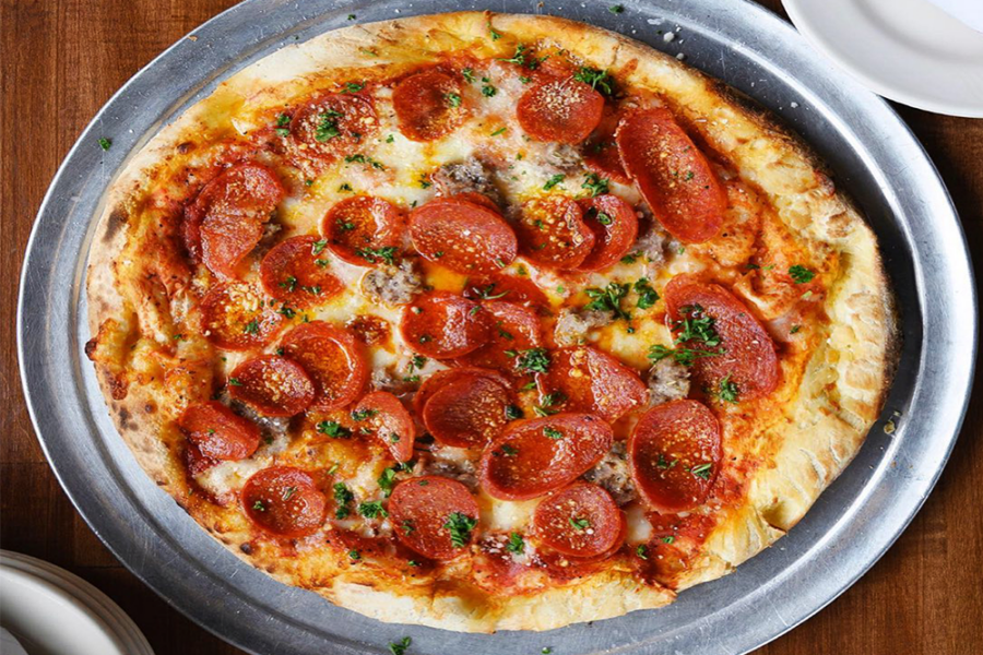 Pizza on silver dish with pepperoni and sausage
