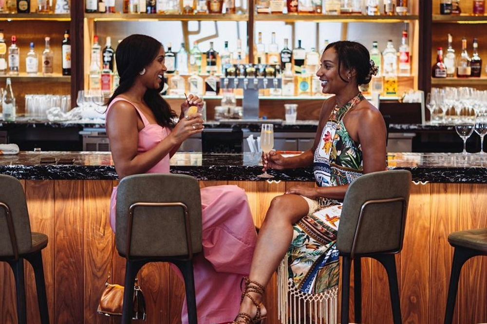 Ladies enjoy drinks at the bar at The Wayward.