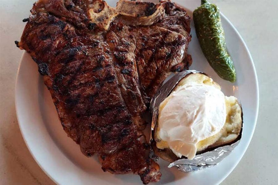 steak, a baked potato, and a green pepper from columbine steakhouse in denver