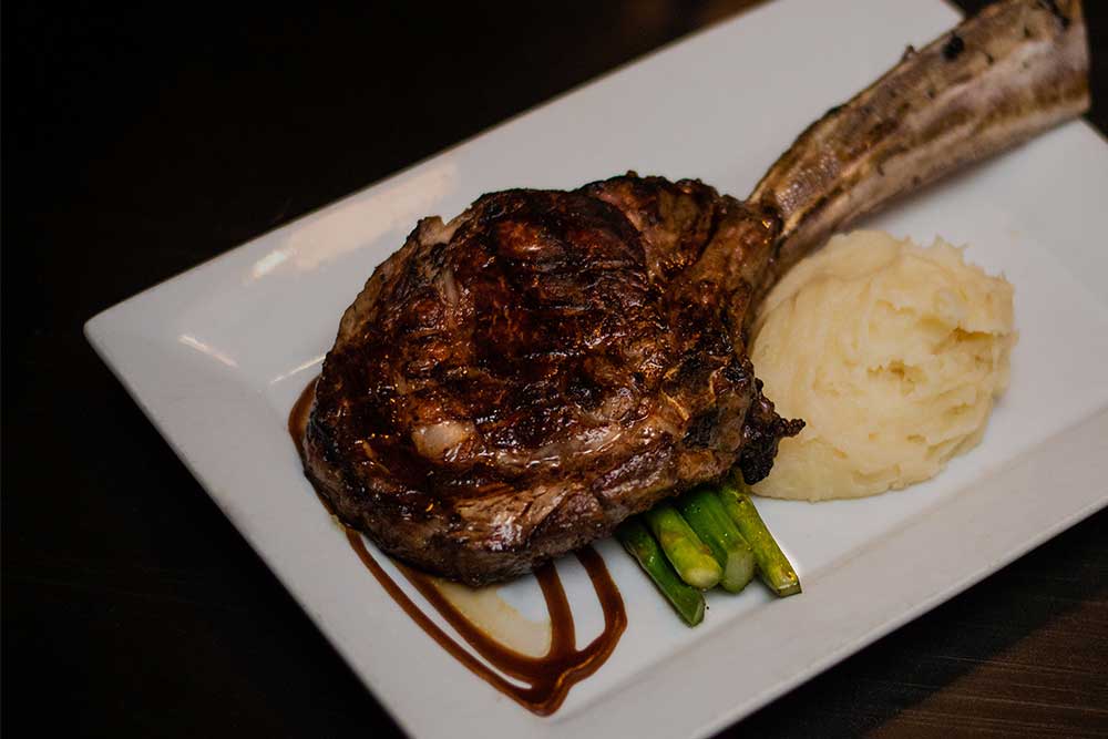 tomahawk steak and mashed potatoes from Steakhouse 10 in Denver