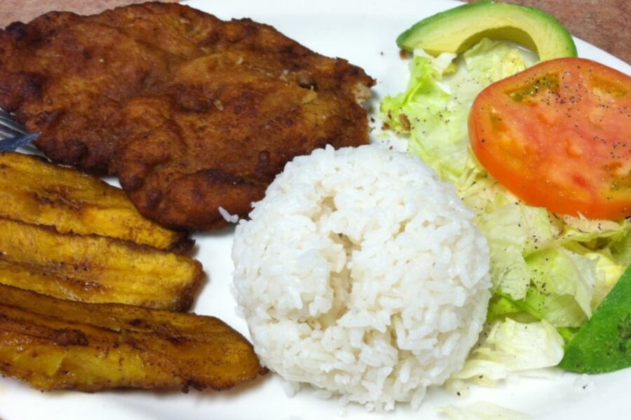 pork chop, white rice, and plantains from La Casona Colombian Restaurant in Denver