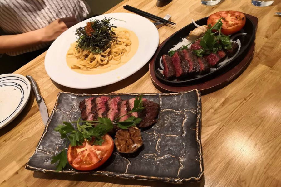 alfredo pasta dish and steak from kokkaku in seattle