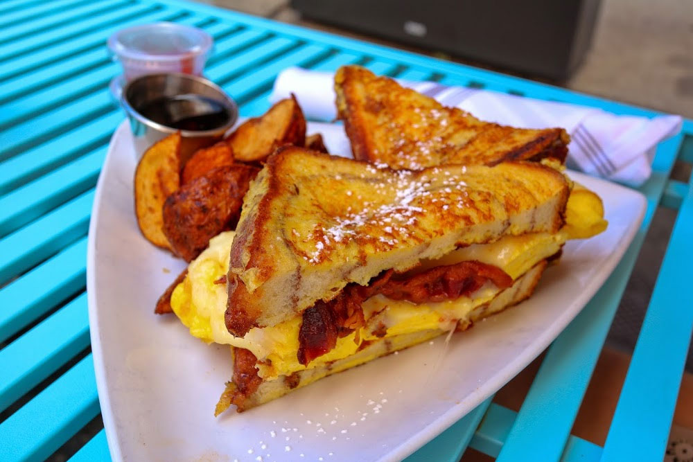 Sweet & Salty Sandwich from North Street Grill. Scrambled eggs, cheddar cheese and bacon on french toast.