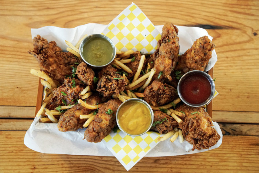 fried chicken tray with fries and sauces from pioneer square drinks and eats in seattle
