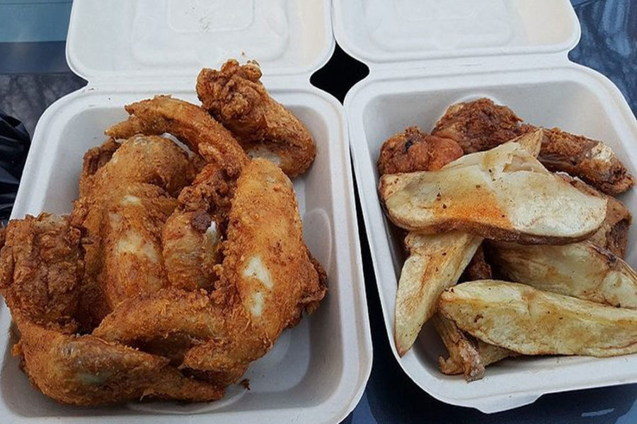 takeout boxes with fried chicken and potatoes wedges from quick pack food mart in seattle