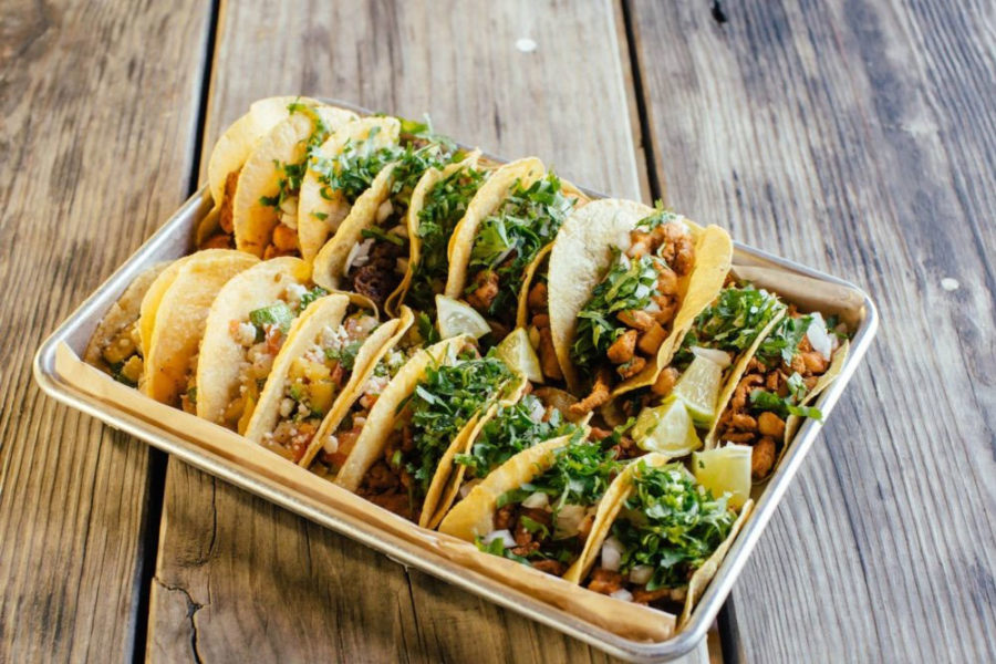 a tray with several tacos from revolver taco lounge in dallas