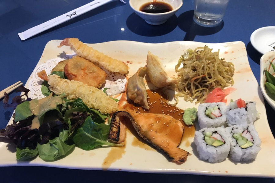 sushi, noodles, wantoon, shrimp tempura, and greens from sushi cho restaurant in tucson