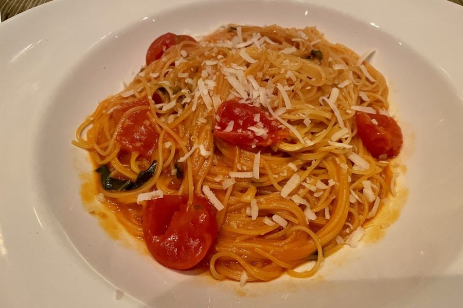 spaghetti with red sauce and baby tomatoes with parmesan sprinkled on top from luce in charlotte
