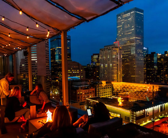 rooftop dining area with a view of denver's skyline at 54thirty 1