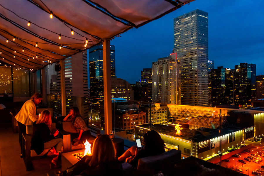 rooftop dining area with a view of denver's skyline at 54thirty 1