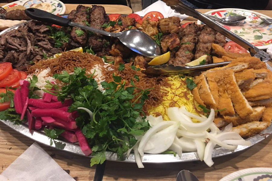 platter with a variety of meats, noodles, tomatoes, and greens from ali baba in san diego