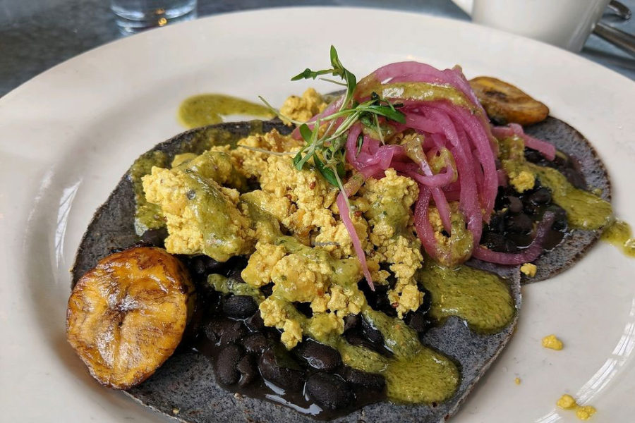 black flour tortilla with black beans, pesto, artichoke, and cabbage from cafe flora in seattle