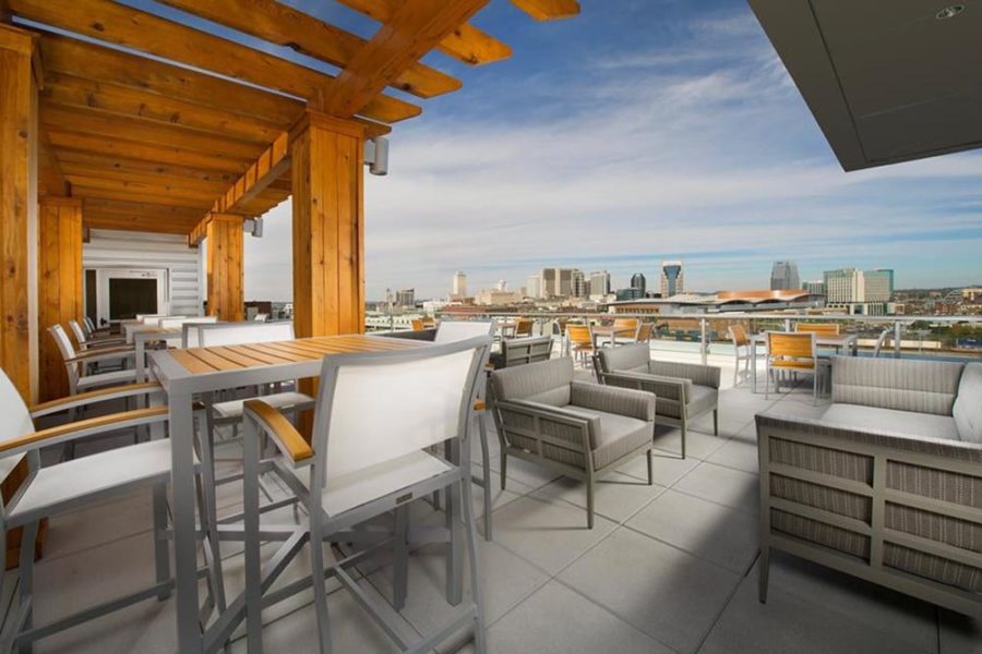 rooftop dining area with a view of nashville at up, a rooftop lounge