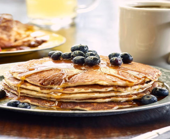 tower of pancakes topped with blueberries with coffee on the side from von elrod's beer hall and kitchen in nashville