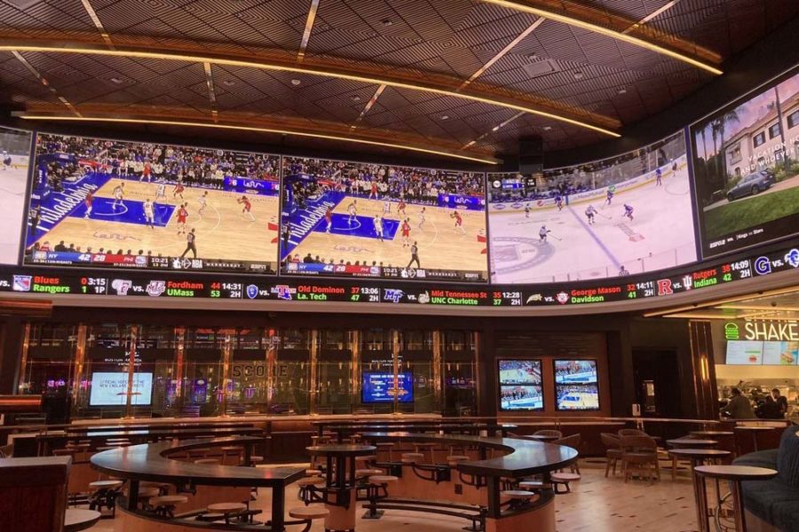 indoor dining surrounded by tvs at wynnBET sports bar in boston