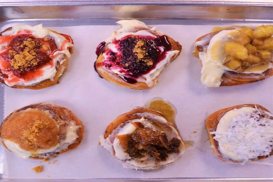cinnamon rolls with various topping like coconut flakes, strawberry puree, pineapple chunks from cinnamon roll deli in columbia, south carolina