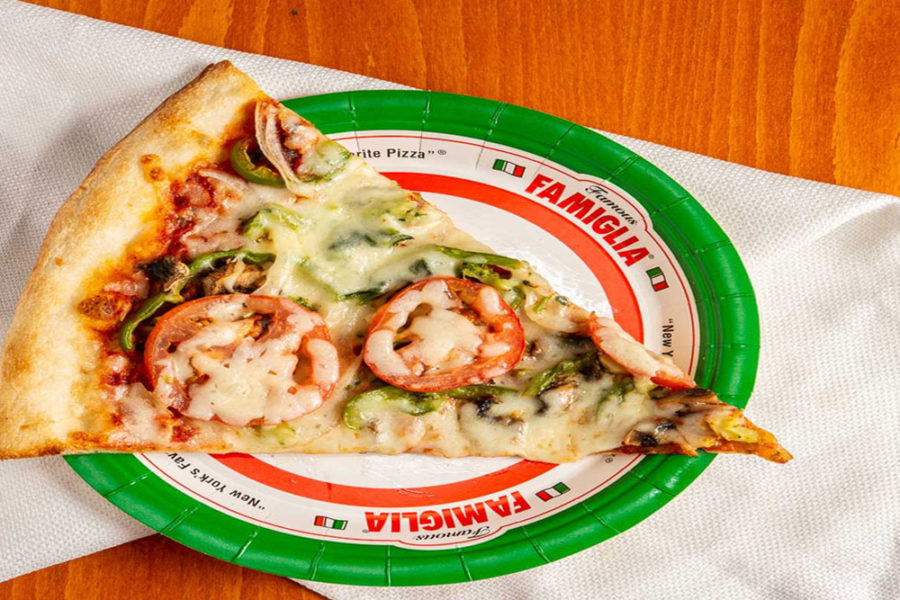 slice of pizza with green peppers and tomato slices from famous famiglia near newark airport