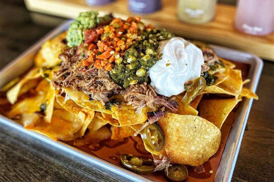 BBQ nachos topped with pico, guac, sour cream, and more