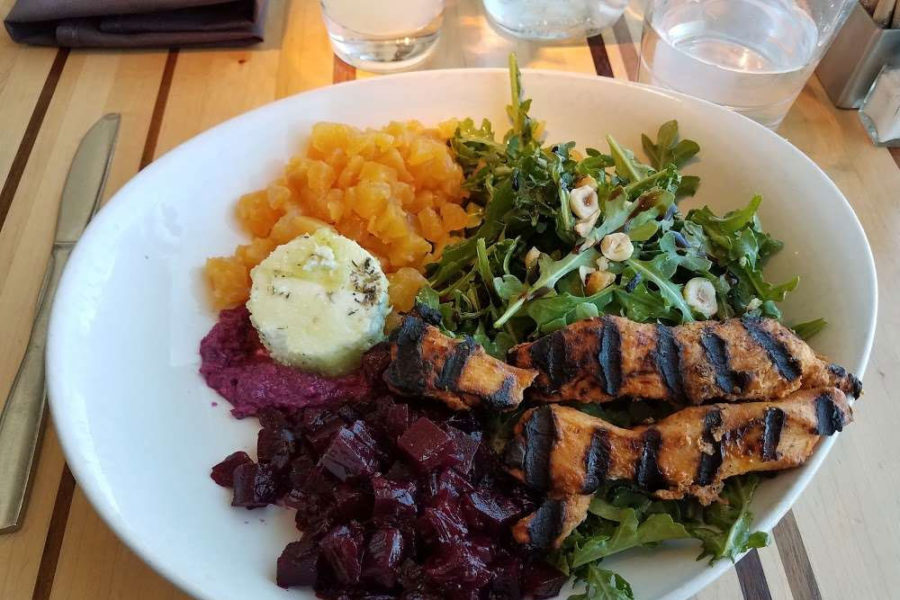 deconstructed salad with chicken, arugula, butternut squash, beetroot, and butter from root down at denver international airport