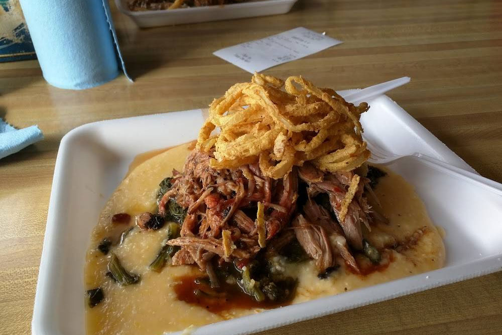 pulled pork in cheese sauce topped with fried calamari from saws soul kitchen near Birmingham-Shuttlesworth International Airport