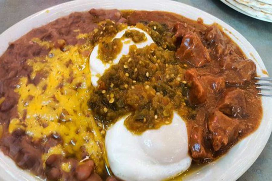 tex-mex dish with refried beans, pork, eggplant, and poached eggs