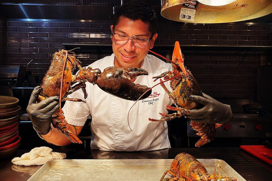 A chef looks at Lobsters at Ch'i in Brickell, Miami.