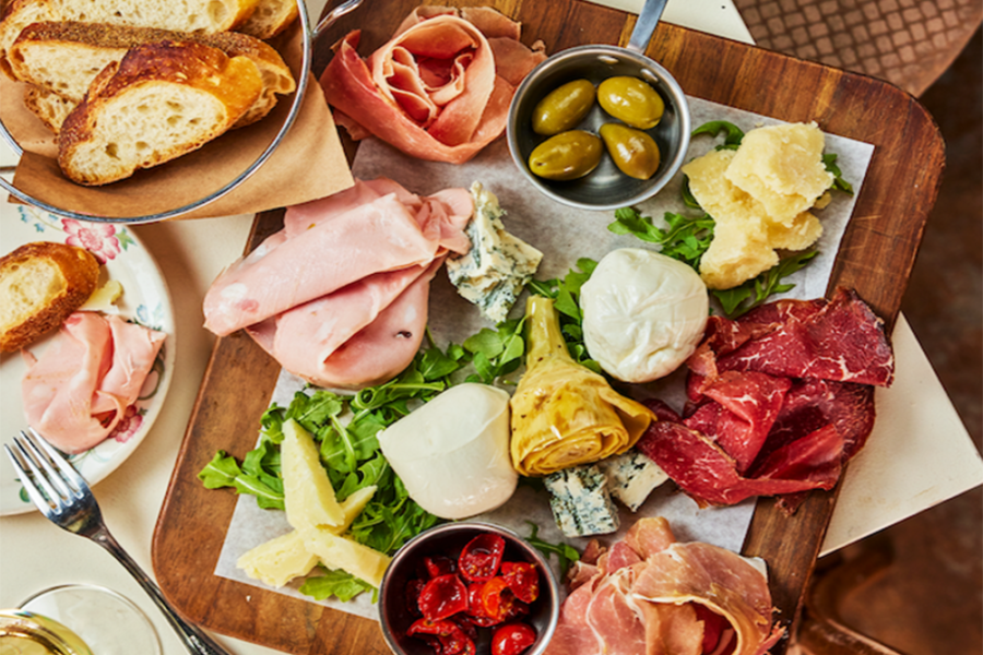 charcuterie board with various cheeses, cold-cuts, and bread from nido cafe in miami