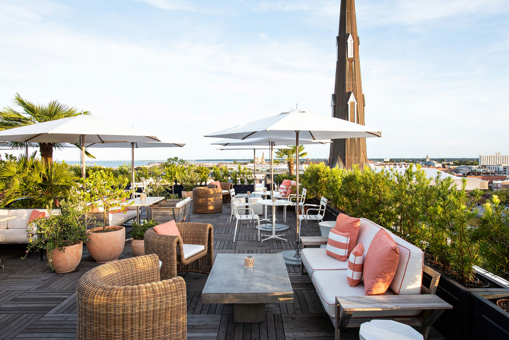 outdoor dining area at citrus club with a view of charleston's waterfront