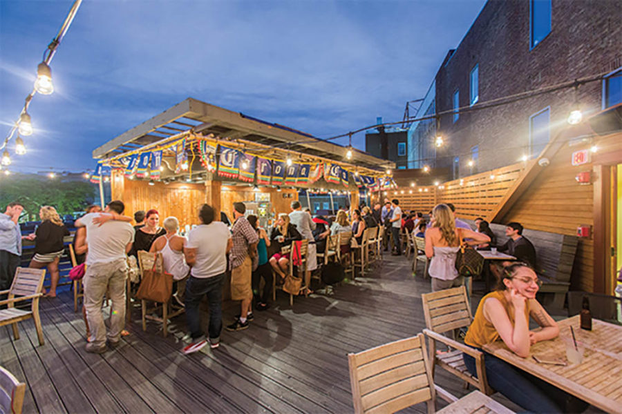 diners enjoying the outdoor bar and dining area at felipa's taqueria in boston