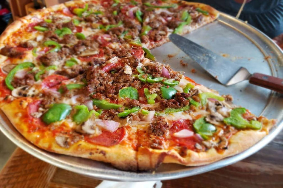 pizza with ground meat, green peppers, ham, and pepperoni from five point in nashville
