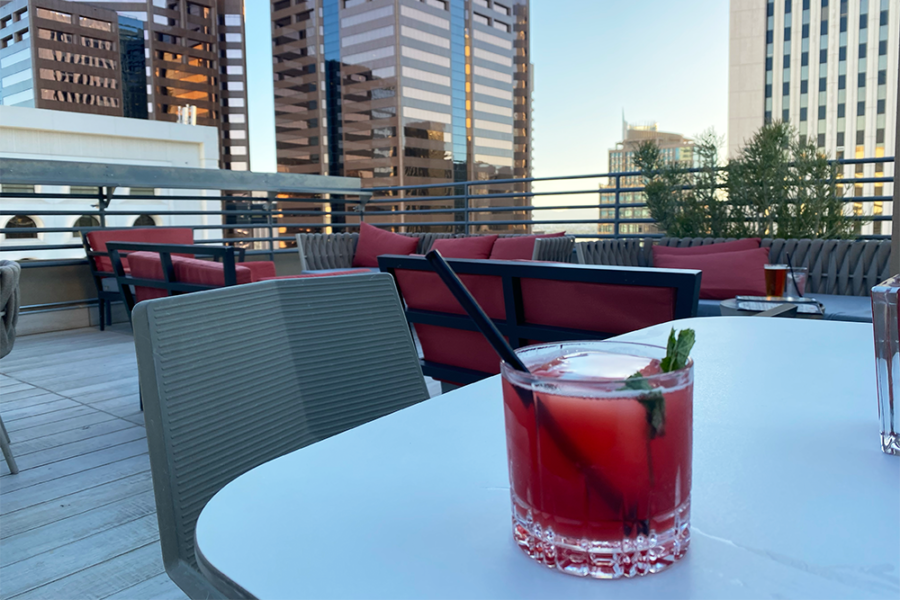 Blackmail cocktail with Kentucky bourbon, blackberry, pomegranate, lime, bitters, flamed cinnamon on rooftop at Floor 13 Rooftop Bar in Phoenix, Arizona