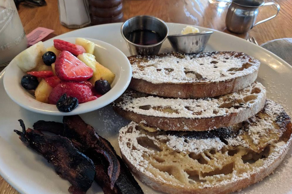 french toast, side of bacon and fresh fruit from Milk and Honey Gulch in Nashville