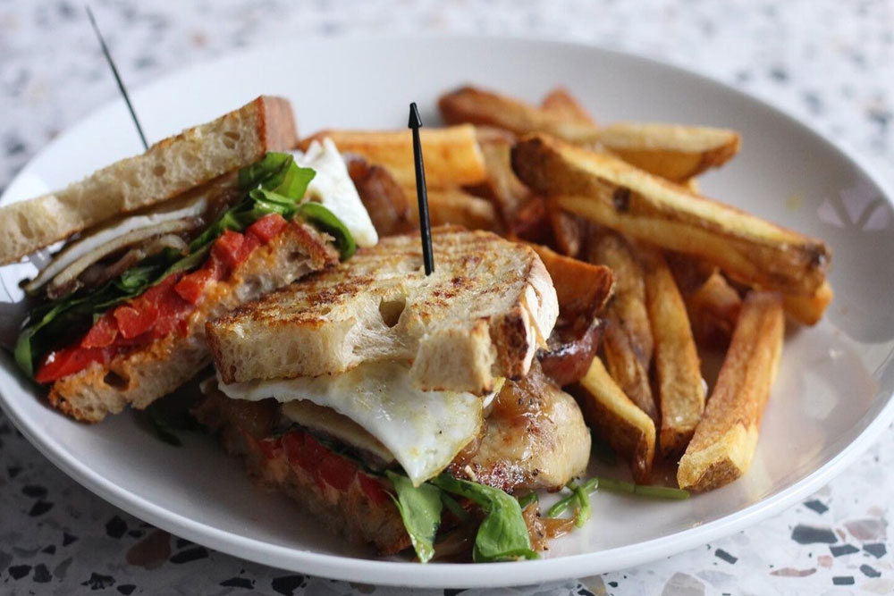 toasted sandwich with a side of fries from Milk and Honey in Nashville