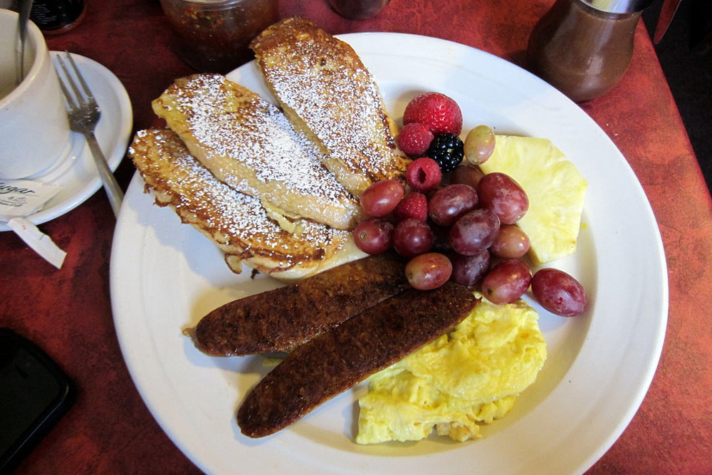 french toast with sausage, eggs, and fresh fruit from Lucile's Creole Cafe in Denver